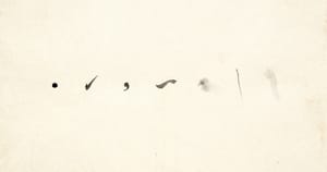 Seven tiny isolated ink marks scattered across vast empty cream washi paper, like notated pauses on an empty staff.